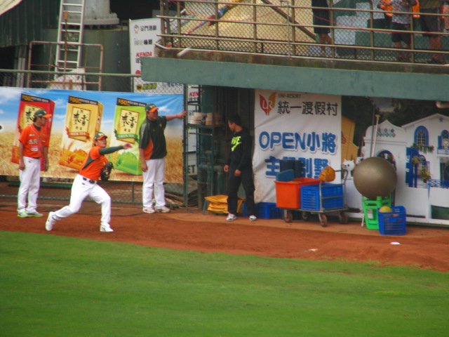 a baseball player on the field in front of an event