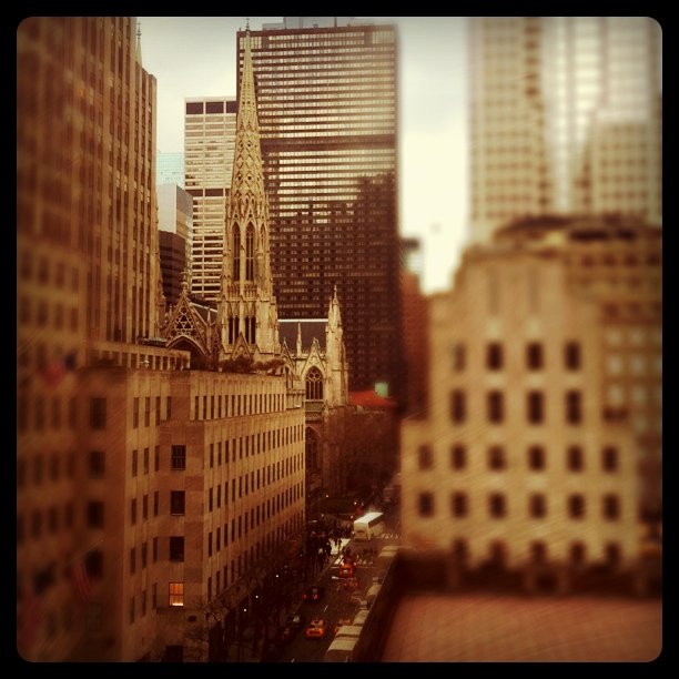 large buildings with steeples stand in a city