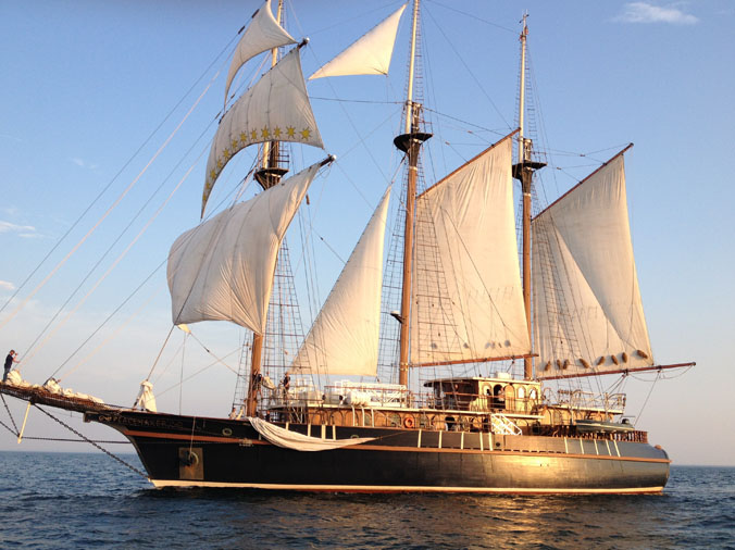 large sailing ship out on the ocean with sails