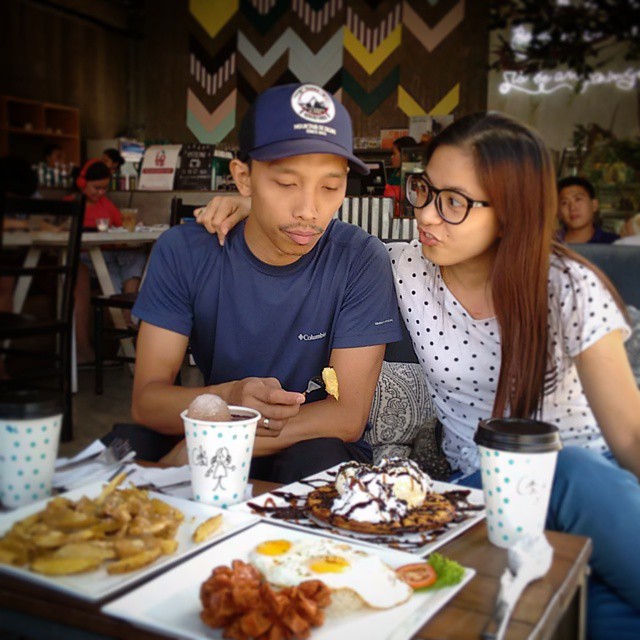 young couple with asian food sitting at a table