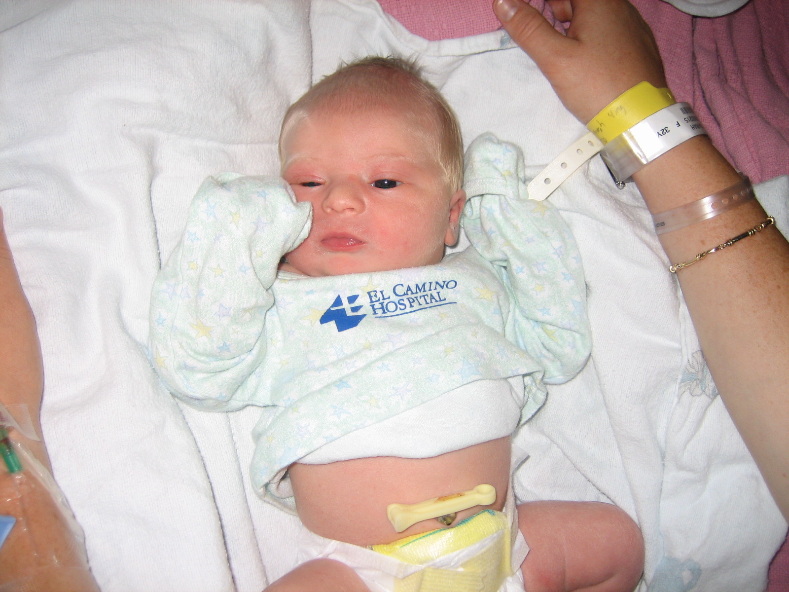 a newborn child laying down on top of a bed