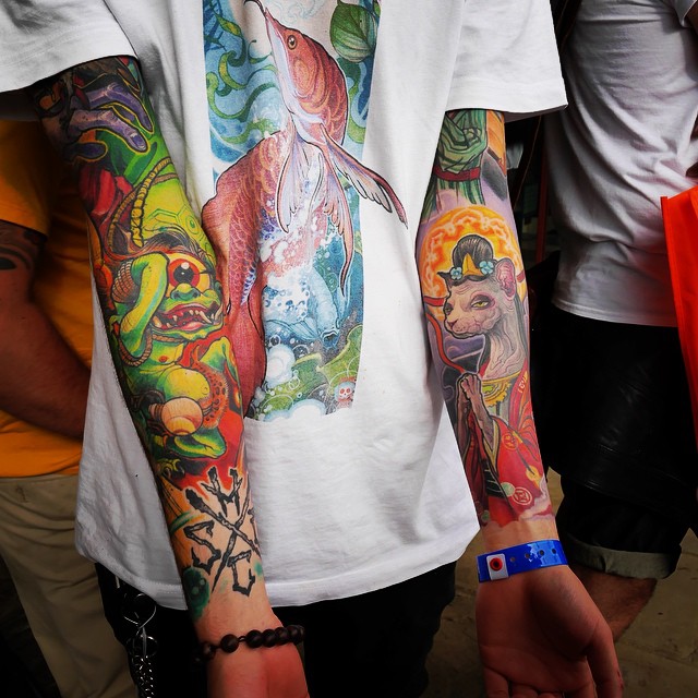 there is a man with many colorful tattoos on his arm
