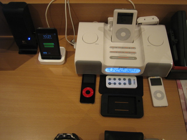 a display case with ipods, an ipod and an mp3 player