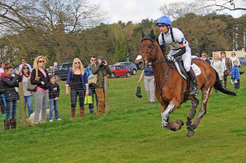 a man riding on the back of a brown horse