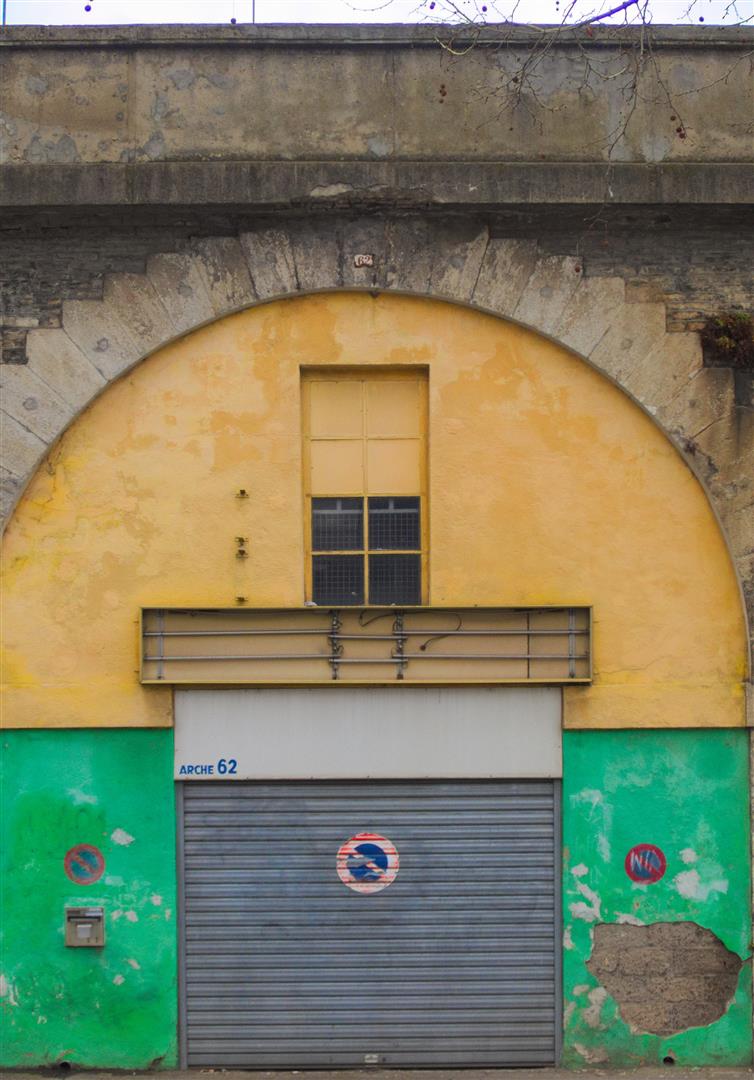 a yellow and green building with two doors