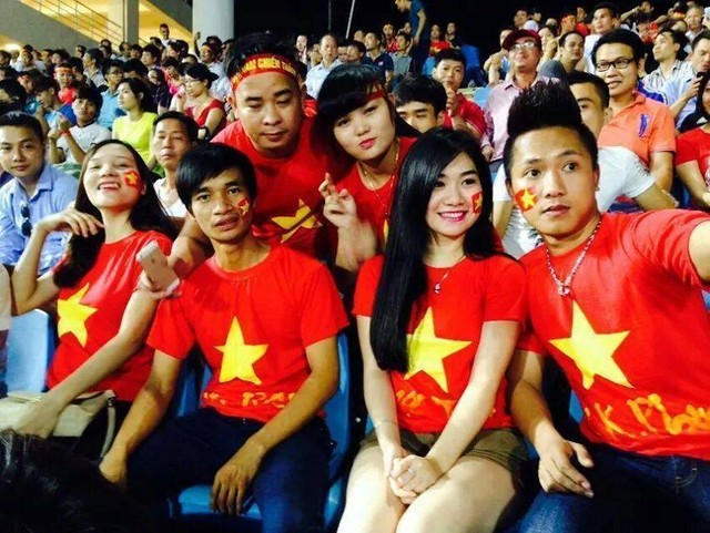a group of people wearing red and yellow shirts with chinese flags on their shirts