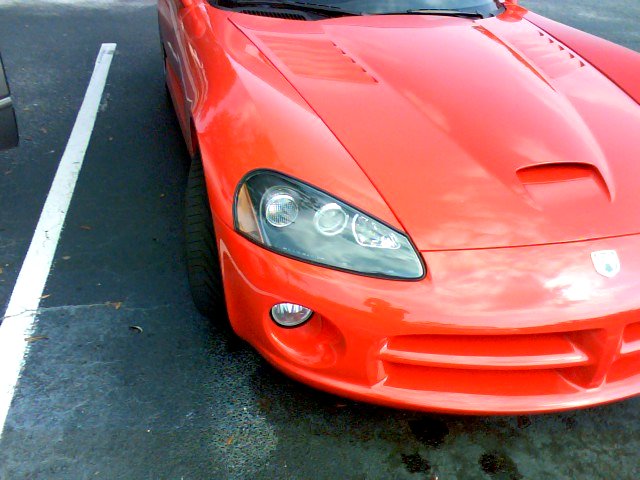a red sports car in the parking lot