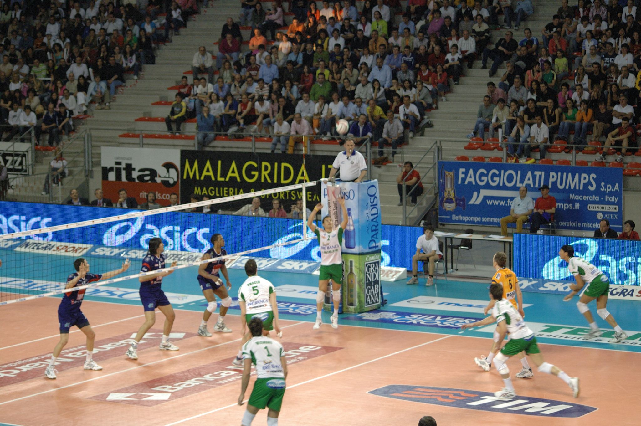 group of men playing a game of volleyball