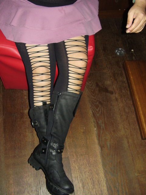 a woman in high boots is wearing stockings and knee length stockings