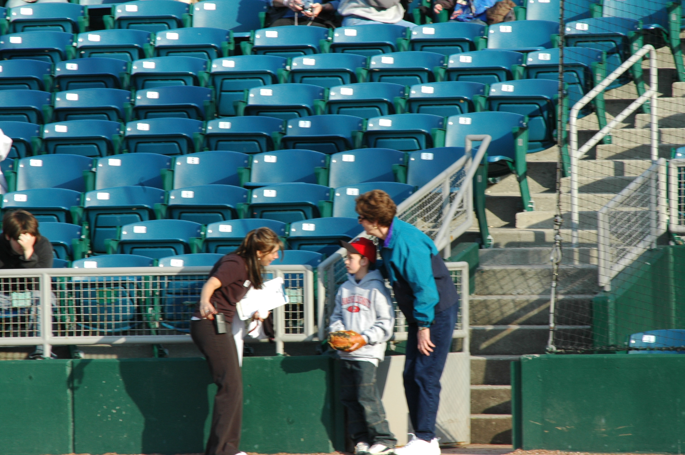 two women standing at the baseball stadium in front of their fans