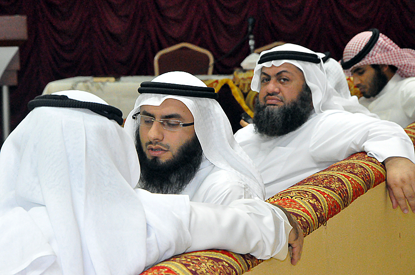 three men in formal attire are looking off into the distance