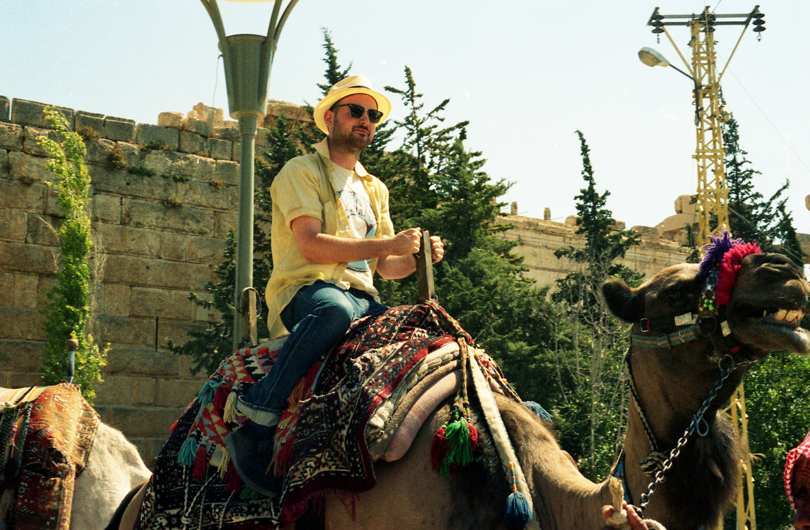 a man riding a camel wearing an elaborate head piece