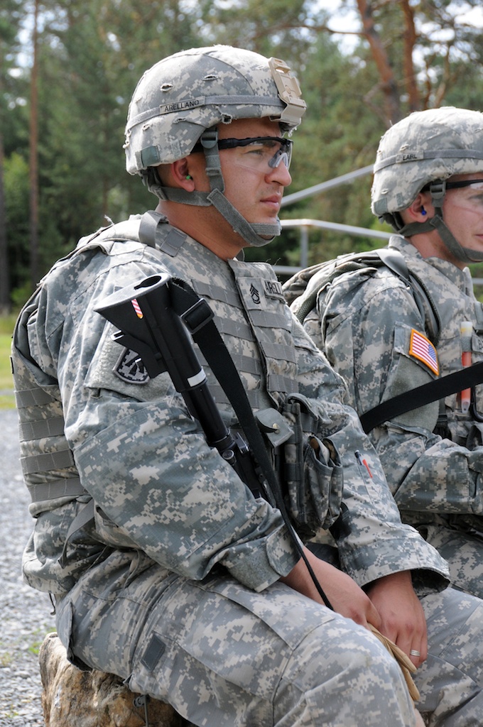 two soldiers are sitting side by side on the side walk