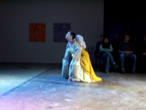 a man sitting on top of a woman in a dress