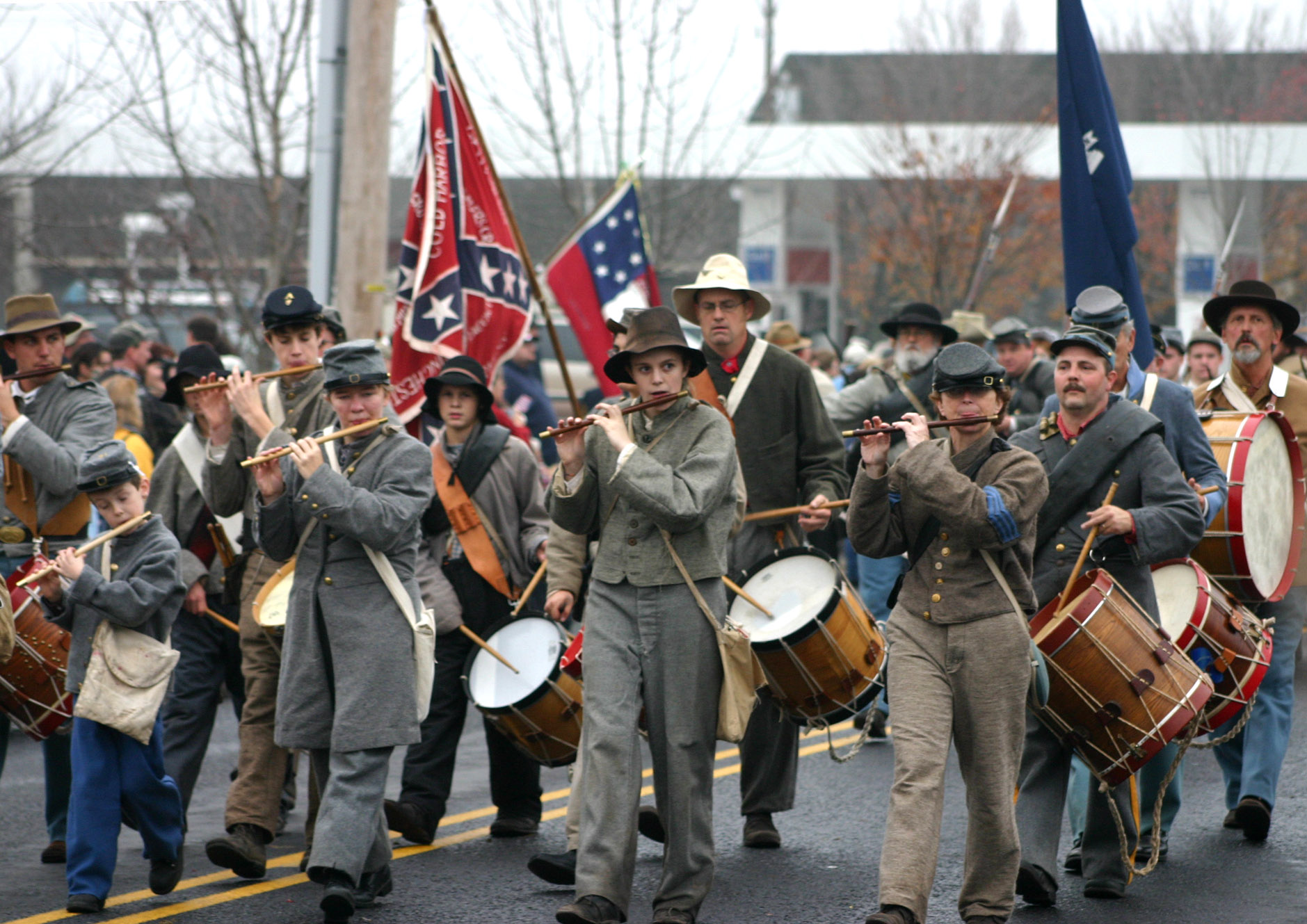 a parade with several people marching in the street