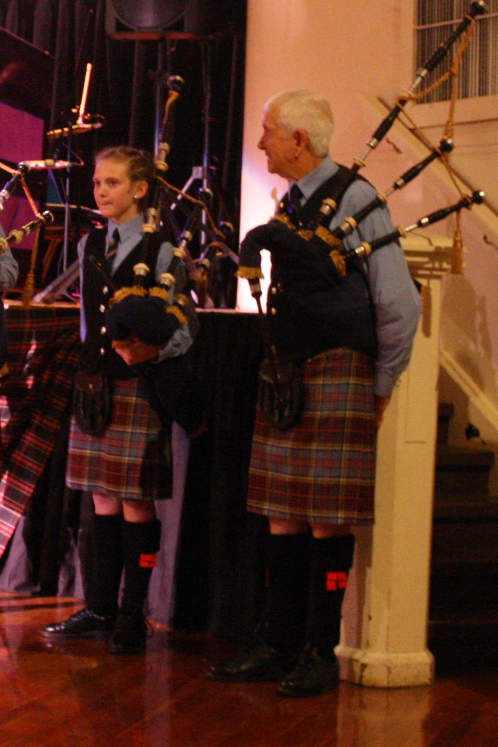 people are dressed in kilts and pipe band attire