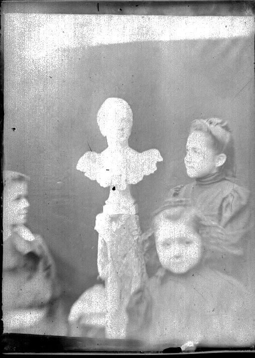 the little girl is sitting in front of a doll