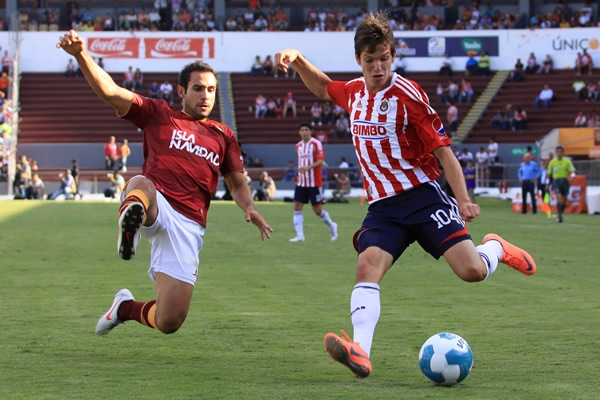 a pair of men on opposing teams playing soccer