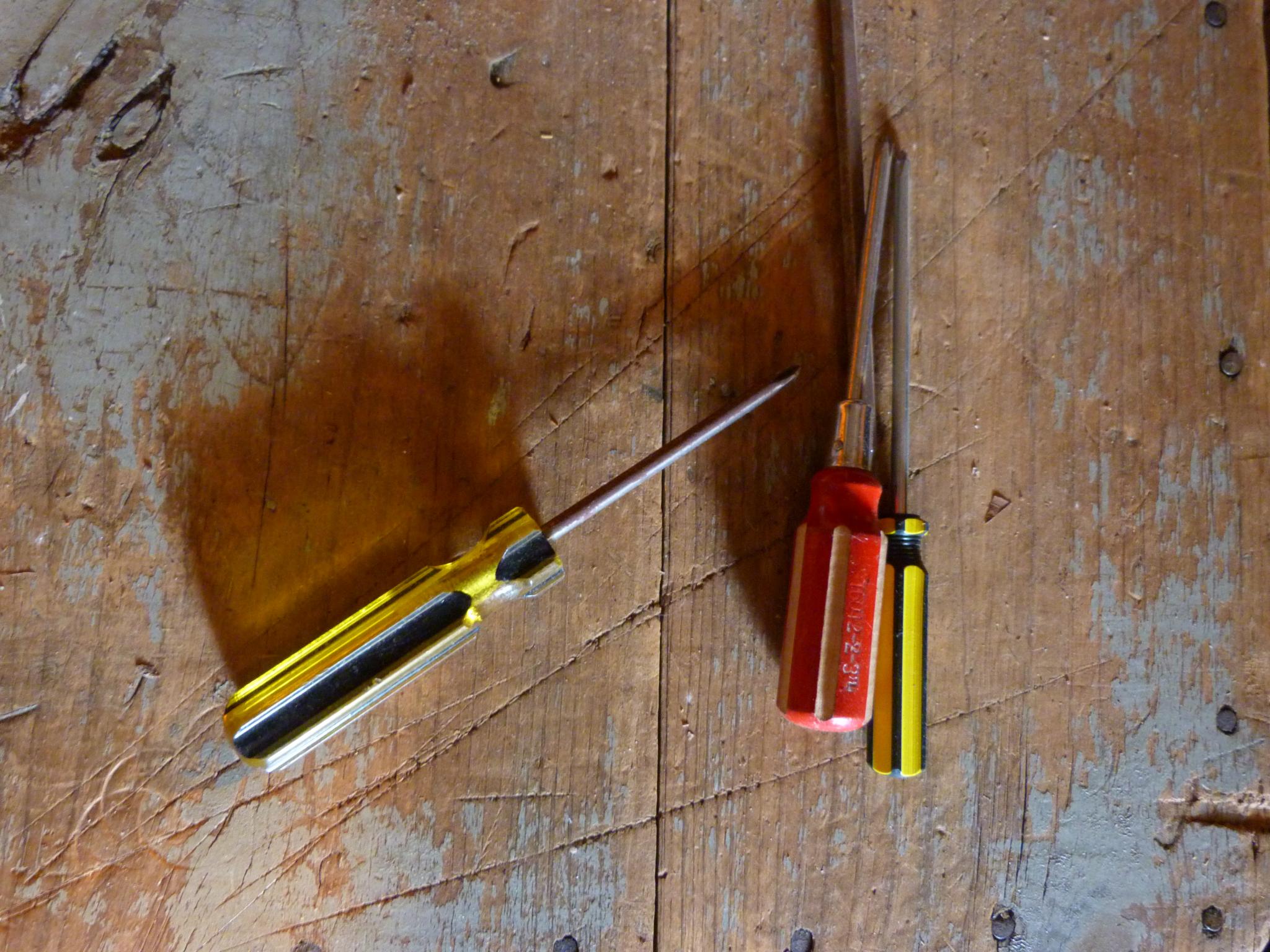 a group of different tools are laying on a wooden surface