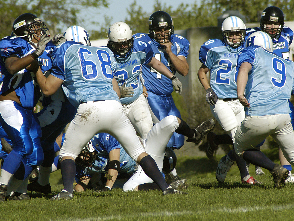 several football players in uniforms playing together