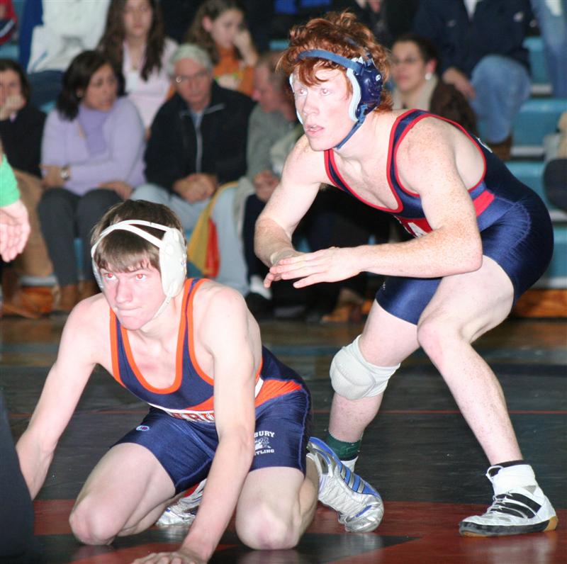 two wrestling wrestlers in their uniforms preparing to compete