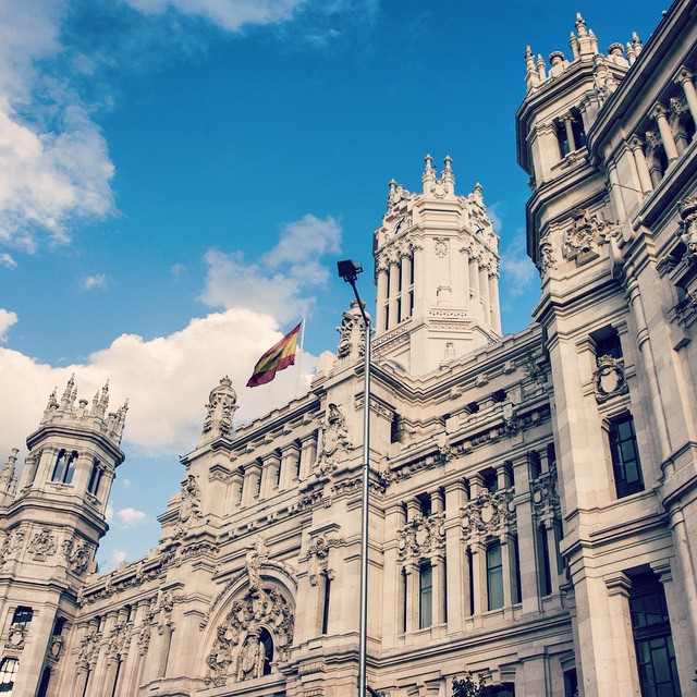 an old building in front of a bright blue sky