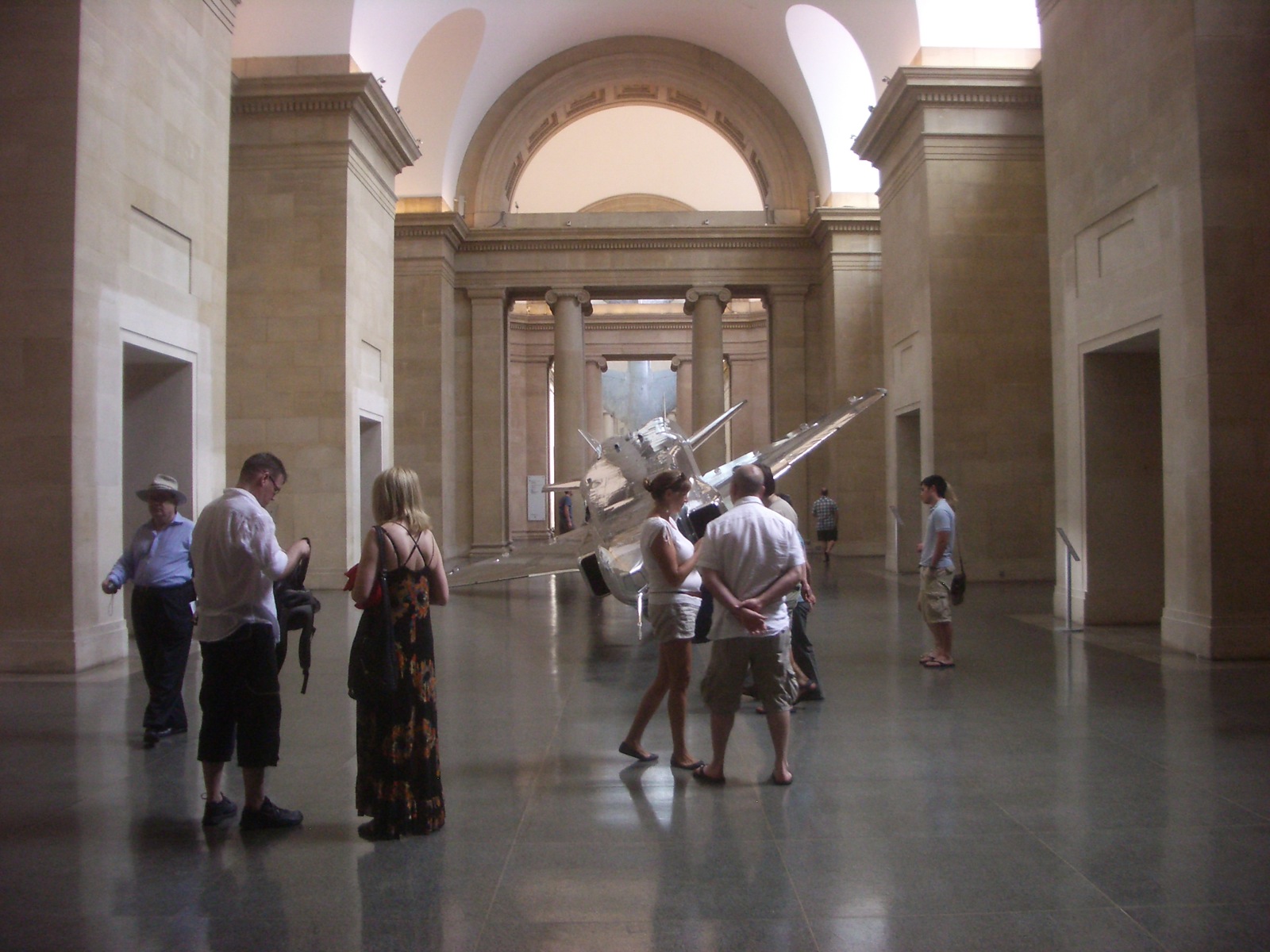 several people are standing in a large building