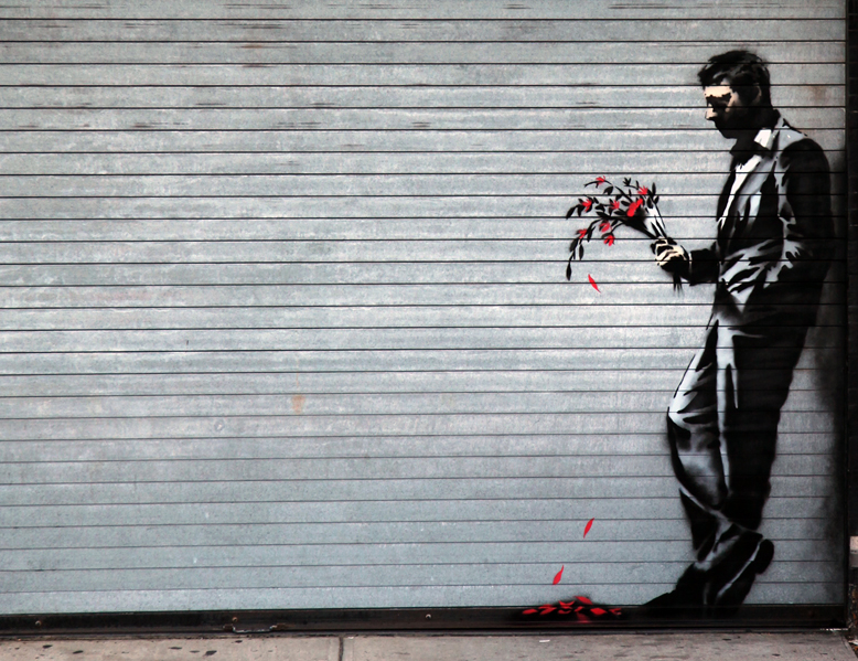 a man holding a vase of flowers is painted on the side of a garage door
