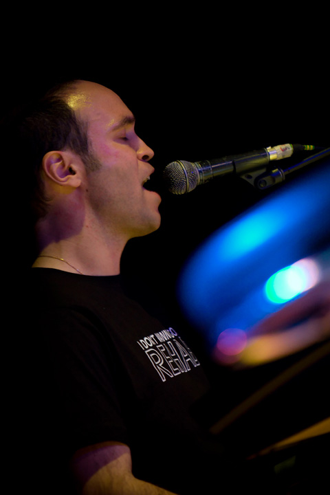 a man playing a instrument on stage at night