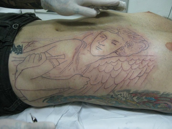 a tattoo of an angel has been shown on a man's leg