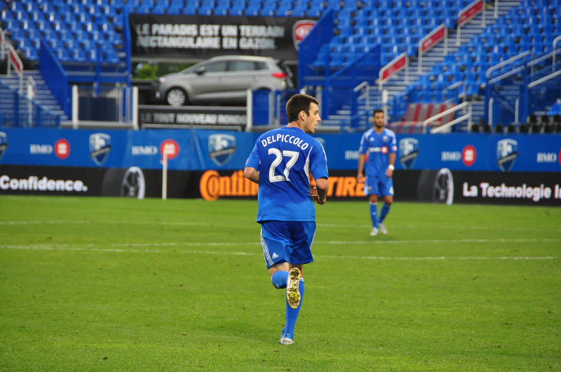 a soccer player on the field running and playing