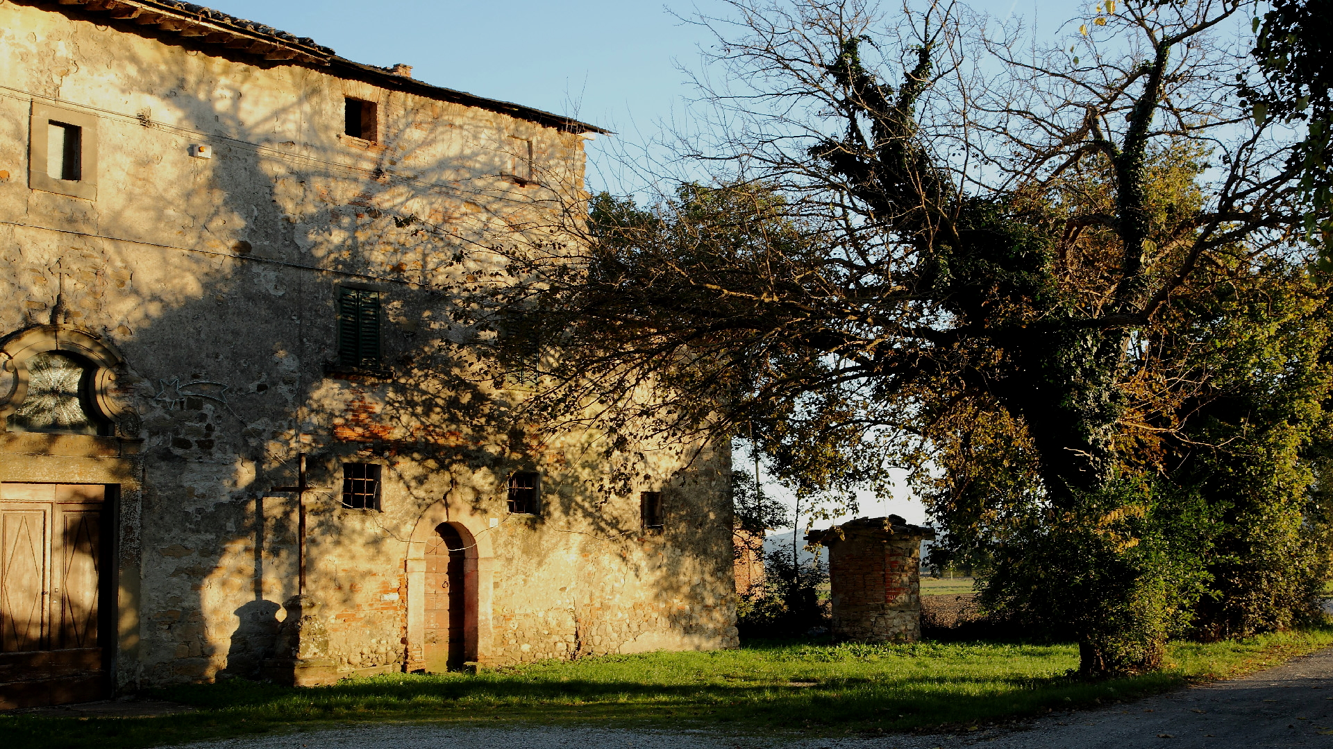 an old stone church is next to an old brick building