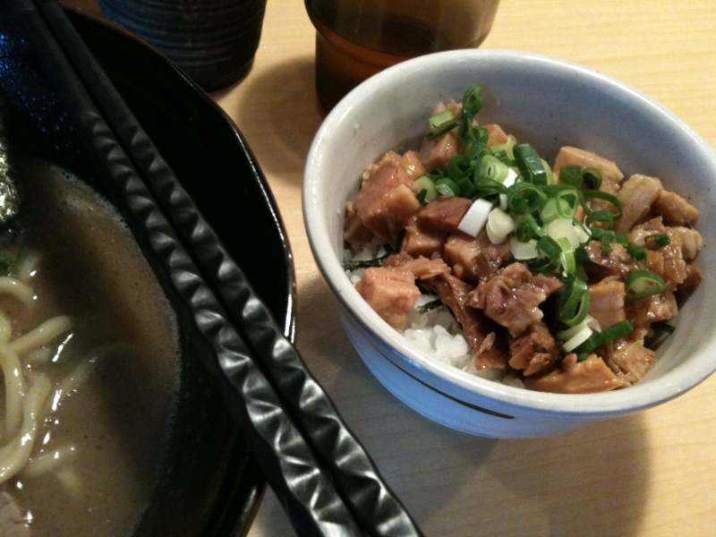 a close - up of a bowl of food and chopsticks