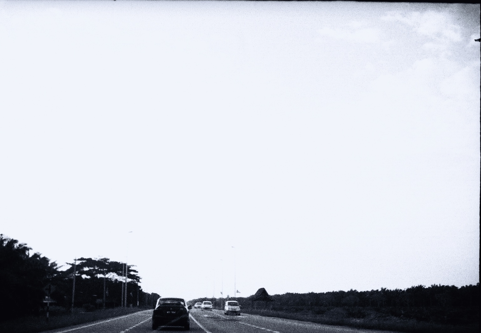 cars driving down a highway on a clear day