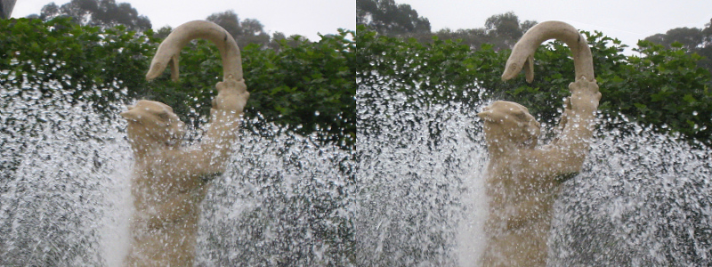 this is a large water fountain featuring two figures making faces