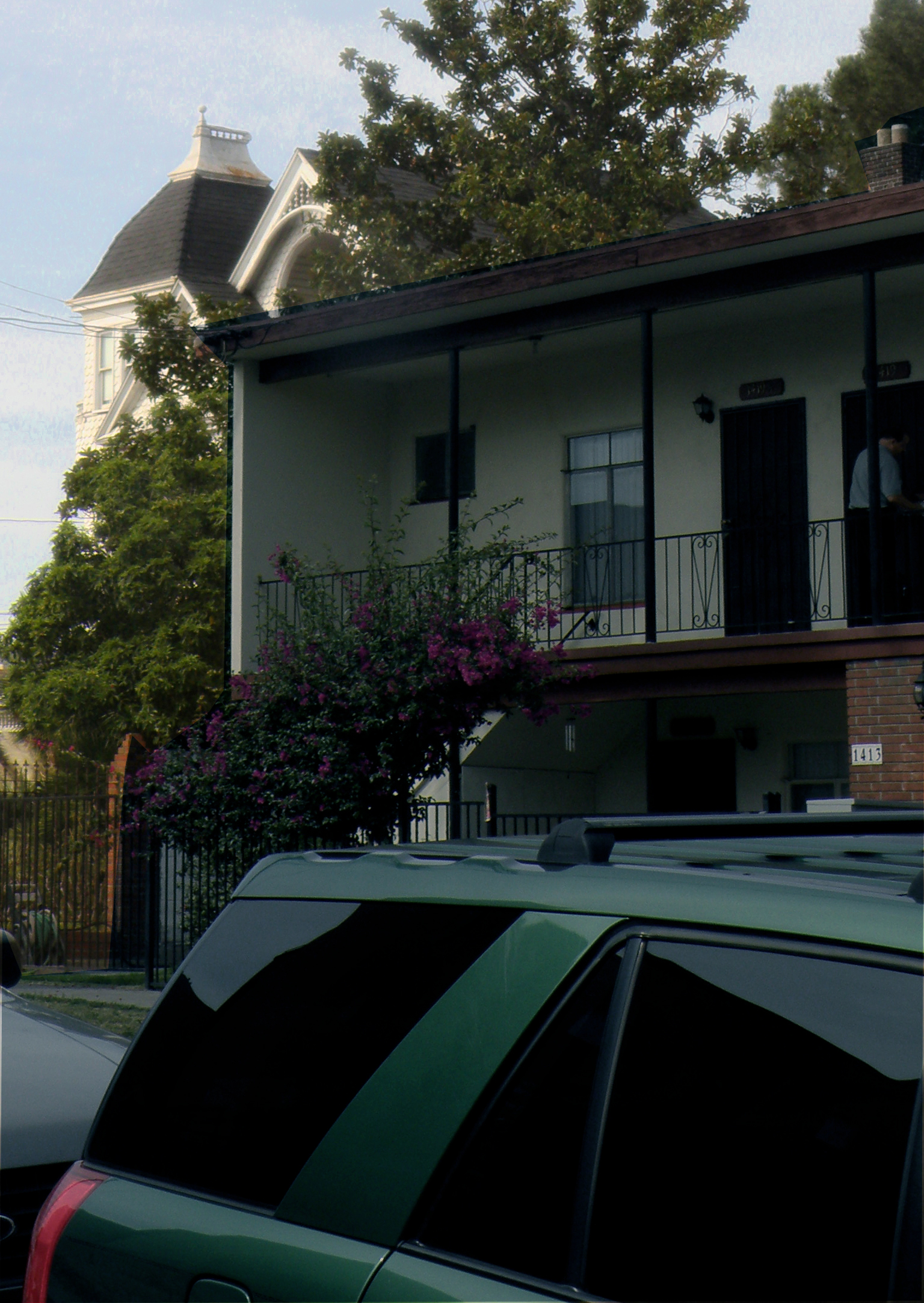 a green van that is parked outside a home