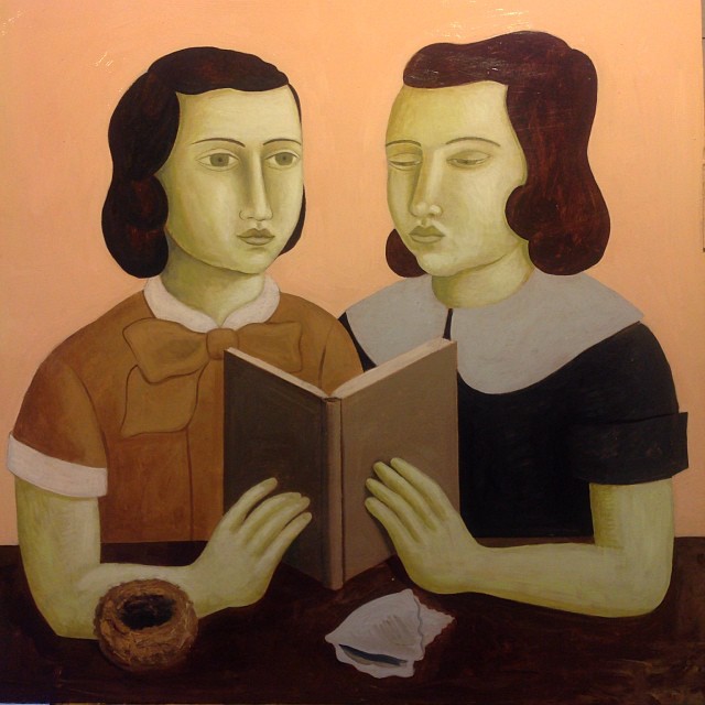 two women reading a book together
