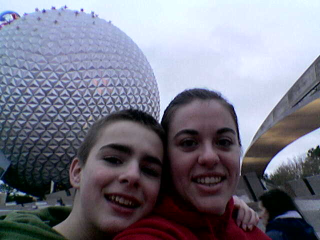 two people standing next to each other in front of an enormous ball