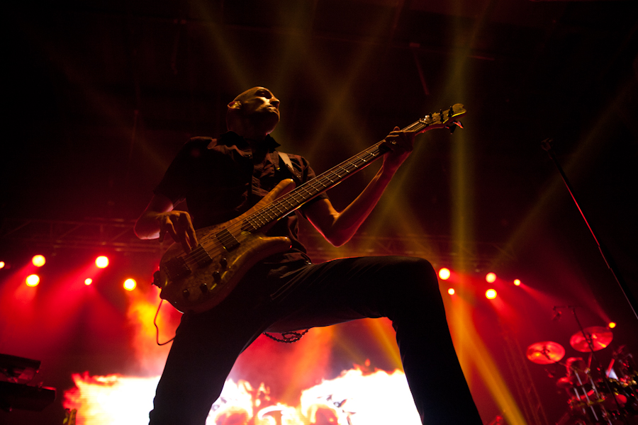 a man is playing on a bass guitar on stage