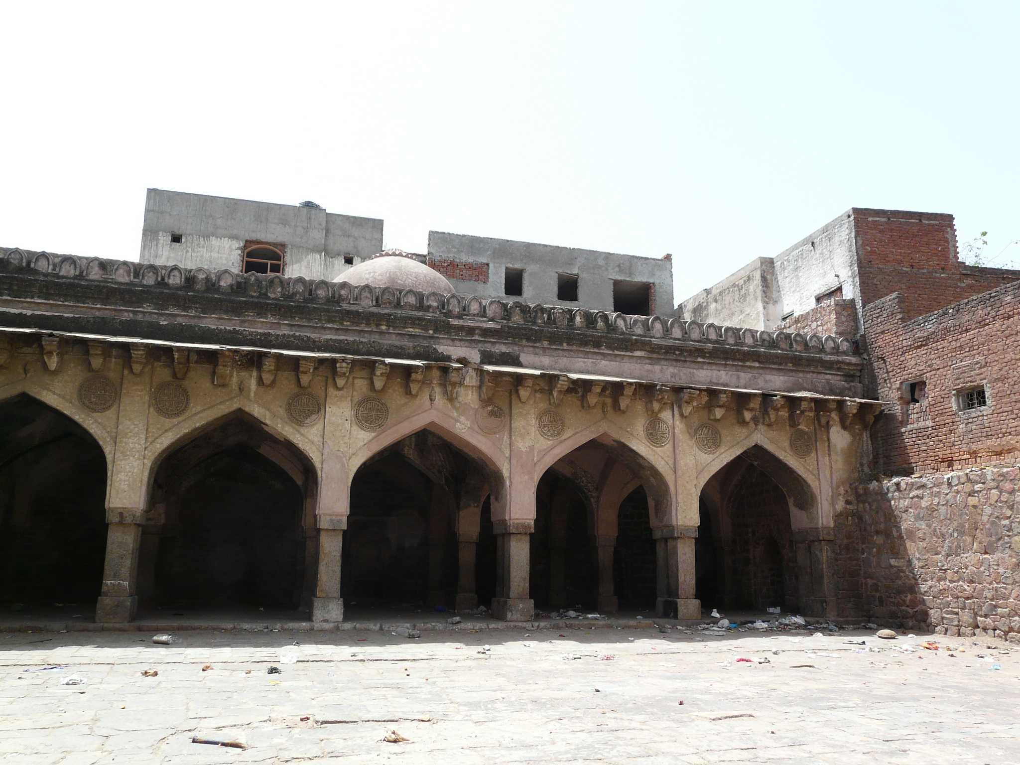 the room in which three people are sitting is surrounded by tall arches