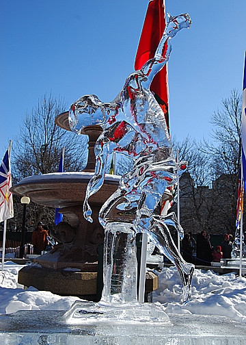 the statue is standing in the snow with flags