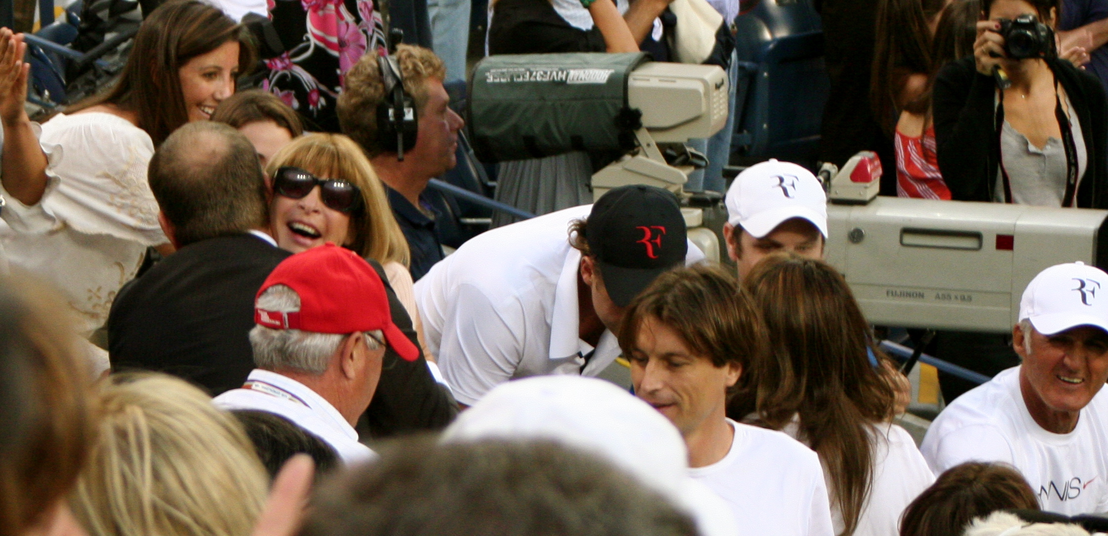 a woman holding her face in the crowd