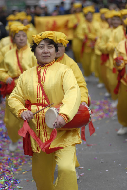 people with drum in yellow outfits are at a parade