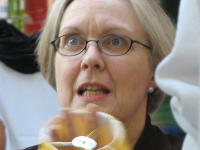 a close up of a woman holding a doughnut