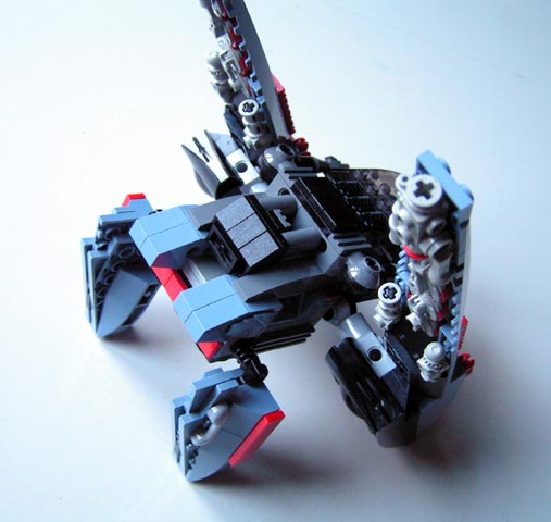 a black lego robot with a huge blade in its hand