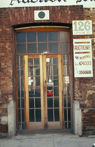 the large brick building has large glass doors