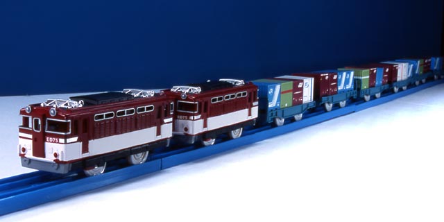 toy train sitting on track with dark background
