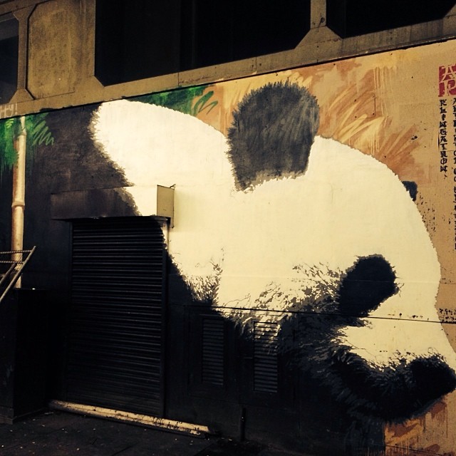 a panda bear is painted on the side of a building