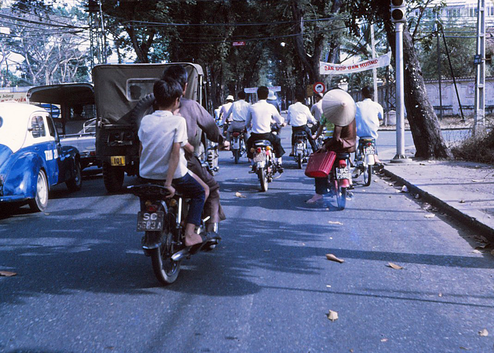 a group of people on motorcycles going down a street