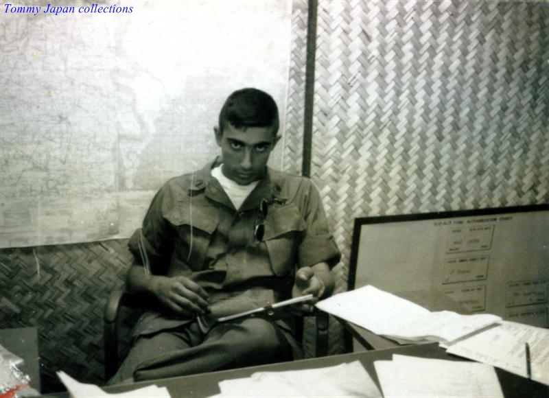 this is an old po of a man in military uniform sitting at a desk